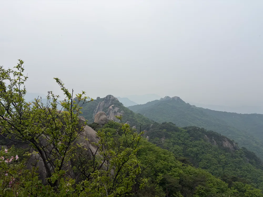 A view over Bukhansan's granite ridges and forested slopes from a peak