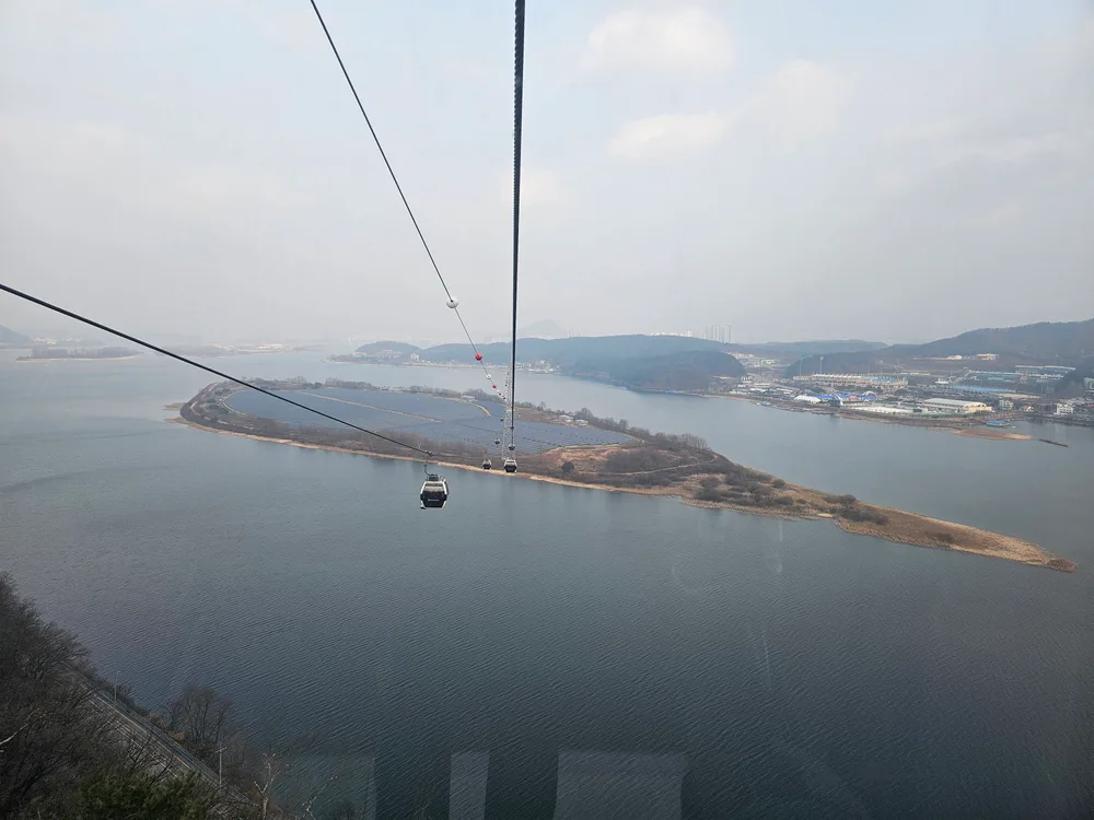 View from a lake cable car over Uiam Lake and a long wooded island near Chuncheon